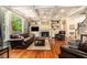 Inviting living room featuring a cozy fireplace, hardwood floors, and built-in shelving at 139 Ardsley Run, Canton, GA 30115