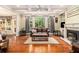 Comfortable living room with a fireplace, hardwood floors, and plenty of natural light at 139 Ardsley Run, Canton, GA 30115