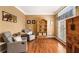 Cozy sitting room featuring hardwood floors, neutral paint, and plenty of natural light at 139 Ardsley Run, Canton, GA 30115