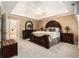 Main bedroom with a tray ceiling, carpet, and a large bed with matching nightstands at 139 Ardsley Run, Canton, GA 30115