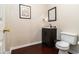 Chic powder room with dark wood vanity, modern fixtures, and elegant decor, perfect for guests at 139 Ardsley Run, Canton, GA 30115