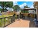 Wooden deck with chairs, table, and sun umbrellas overlooking a large grassy fenced in backyard at 2349 June Springs Sw Dr, Marietta, GA 30008