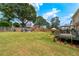 Large backyard features a grassy lawn, a wooden deck, sitting area, and privacy fencing at 2349 June Springs Sw Dr, Marietta, GA 30008