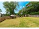 Spacious backyard featuring a shed, grassy lawn, and a wooden privacy fence at 2349 June Springs Sw Dr, Marietta, GA 30008