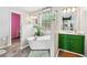 Elegant bathroom featuring a freestanding tub, bright green cabinets, and stylish decor at 2349 June Springs Sw Dr, Marietta, GA 30008