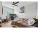 Bedroom with wood floors featuring a window view, ceiling fan, and desk with computer monitors at 2349 June Springs Sw Dr, Marietta, GA 30008