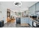A kitchen with grey cabinets, stainless steel appliances and a view into the living room at 2349 June Springs Sw Dr, Marietta, GA 30008