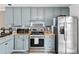 Updated kitchen featuring stainless steel appliances, stylish backsplash, and light grey cabinets at 2349 June Springs Sw Dr, Marietta, GA 30008