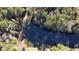 Aerial shot of the property's serene lake, surrounded by lush trees and a dock at 337 Andrew Bailey Rd, Sharpsburg, GA 30277