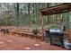 Back deck with built-in bench seating, covered area, and stainless steel barbecue grill at 337 Andrew Bailey Rd, Sharpsburg, GA 30277