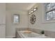 Bathtub featuring tile surround and built-in jets with a decorative light fixture at 337 Andrew Bailey Rd, Sharpsburg, GA 30277