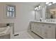 Bathroom featuring double sinks, decorative mirrors, and neutral color palette at 337 Andrew Bailey Rd, Sharpsburg, GA 30277