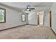 Spacious bedroom with a ceiling fan and ensuite bathroom entrance; brightened by windows at 337 Andrew Bailey Rd, Sharpsburg, GA 30277