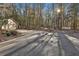 Gravel driveway leading up to house with detached garage and shed with lots of trees at 337 Andrew Bailey Rd, Sharpsburg, GA 30277
