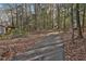 A long driveway stretches through a wooded area, leading to the property with mature trees on either side at 337 Andrew Bailey Rd, Sharpsburg, GA 30277