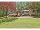 Landscaped front yard and inviting front porch on ranch home with red shutters and door at 337 Andrew Bailey Rd, Sharpsburg, GA 30277