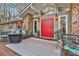 Cozy front porch featuring a stylish seating area and double red doors at 337 Andrew Bailey Rd, Sharpsburg, GA 30277