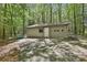 Exterior view of detached garage with paved driveway surrounded by a forest at 337 Andrew Bailey Rd, Sharpsburg, GA 30277