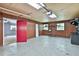 View of garage showing wooden walls, concrete floors, and two windows that provide natural light at 337 Andrew Bailey Rd, Sharpsburg, GA 30277