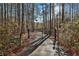 View of property gate surrounded by mature trees for privacy and seclusion at 337 Andrew Bailey Rd, Sharpsburg, GA 30277