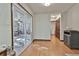 Hallway with hardwood floors, slider to sunroom, and view of the utility area at 337 Andrew Bailey Rd, Sharpsburg, GA 30277
