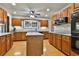 Well-lit kitchen featuring granite countertops, wood cabinets, and an island at 337 Andrew Bailey Rd, Sharpsburg, GA 30277
