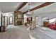 Open living room with stone fireplace, wood beams and neutral decor at 337 Andrew Bailey Rd, Sharpsburg, GA 30277
