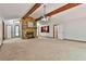 Spacious living room with a stone fireplace, wood beams and natural light at 337 Andrew Bailey Rd, Sharpsburg, GA 30277