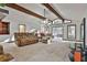 Bright living room with exposed beams, fireplace, and comfortable seating at 337 Andrew Bailey Rd, Sharpsburg, GA 30277