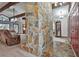 Spacious living room with a stone fireplace and exposed wood beams at 337 Andrew Bailey Rd, Sharpsburg, GA 30277