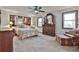 Well-lit main bedroom featuring warm decor, built-in shelving, comfortable seating, and two windows at 337 Andrew Bailey Rd, Sharpsburg, GA 30277