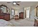 Bright main bedroom features a ceiling fan, sitting area, and natural light at 337 Andrew Bailey Rd, Sharpsburg, GA 30277