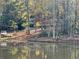 Picturesque shot of a serene pond reflecting the fall colors with a house situated amongst the trees at 337 Andrew Bailey Rd, Sharpsburg, GA 30277