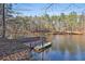 Private pond featuring a relaxing dock with a small boat, perfect for leisure at 337 Andrew Bailey Rd, Sharpsburg, GA 30277