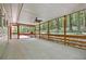 Open view of large screened porch overlooking a wooded backyard and spacious deck at 337 Andrew Bailey Rd, Sharpsburg, GA 30277