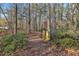 Nature trail leading through a wooded area with privacy fence in view at 337 Andrew Bailey Rd, Sharpsburg, GA 30277