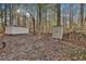 Property featuring wooded area and two storage sheds at 337 Andrew Bailey Rd, Sharpsburg, GA 30277
