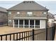 Spacious backyard with a screened-in porch and black aluminum fence, perfect for outdoor living at 3566 Andover Way, Buford, GA 30519