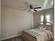 This is a bedroom with tan walls, carpet, standard ceiling fan, and a decorative headboard at 3566 Andover Way, Buford, GA 30519