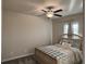 This is a bedroom with tan walls, carpet, standard ceiling fan, and a decorative headboard at 3566 Andover Way, Buford, GA 30519