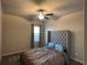 Bedroom with tan walls, carpet, standard ceiling fan, and a gray decorative headboard at 3566 Andover Way, Buford, GA 30519