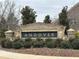 Community sign for Andover is made of stone and brick and surrounded by manicured greenery at 3566 Andover Way, Buford, GA 30519