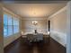 Elegant dining room featuring hardwood floors, wainscoting, and a stylish chandelier at 3566 Andover Way, Buford, GA 30519
