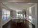 Bright dining room features hardwood floors, decorative molding and stylish chandelier over the marble table at 3566 Andover Way, Buford, GA 30519
