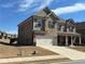 Charming two-story house with brick exterior, covered porch, and attached two-car garage at 3566 Andover Way, Buford, GA 30519