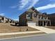 Traditional two-story home boasts a two-car garage, brick facade, and manicured lawn at 3566 Andover Way, Buford, GA 30519