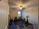 Inviting at-home gym with exercise bike, weights, and a ceiling fan for a comfortable workout at 3566 Andover Way, Buford, GA 30519