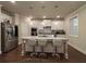Modern kitchen with a granite island, stainless steel appliances, and white cabinetry at 3566 Andover Way, Buford, GA 30519