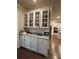 Kitchen cabinet with white frame and glass front, featuring granite countertop at 3566 Andover Way, Buford, GA 30519
