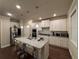 Kitchen with stainless appliances, white cabinetry, large island, and granite countertops at 3566 Andover Way, Buford, GA 30519